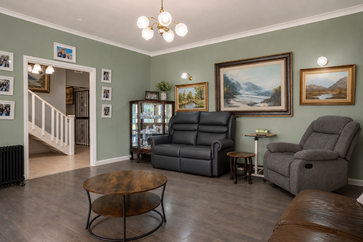 A well-maintained living room featuring sage green walls, wood-look flooring, and a staircase leading to the upper level.