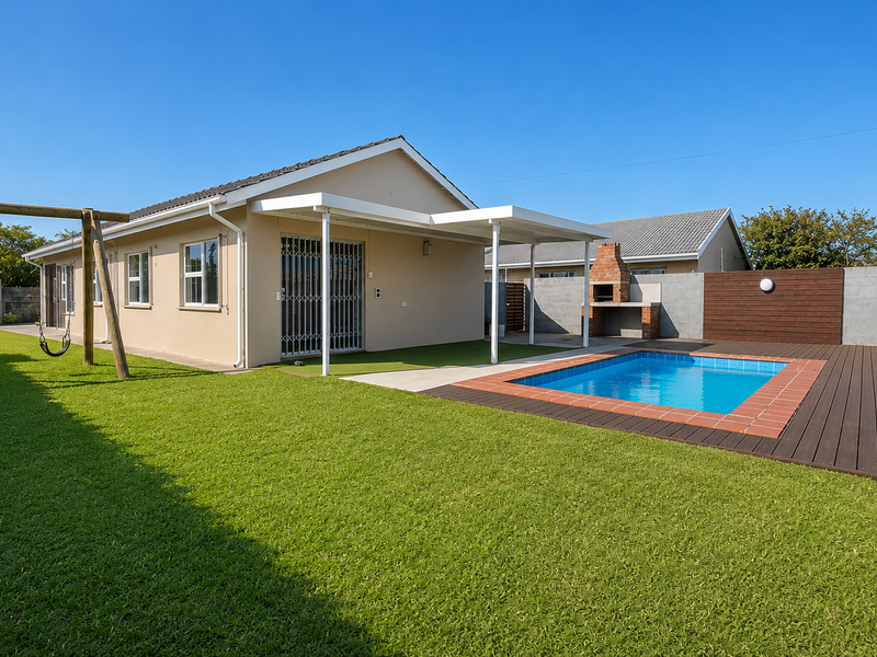 Rear garden featuring a swimming pool, timber decking, covered patio, and a built-in brick braai area, perfect for outdoor entertaining.