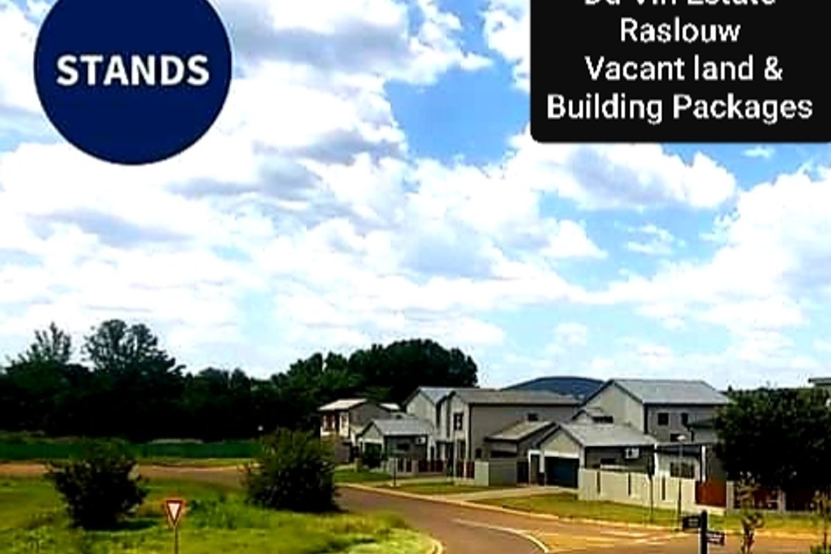 A street-level view of the Du Vin Estate in Raslouw, showcasing available vacant land and existing residential building packages within the development.
