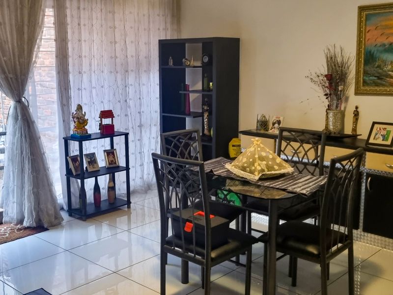 Open plan living and dining area featuring tiled flooring and a sliding glass door providing access to the rear patio.