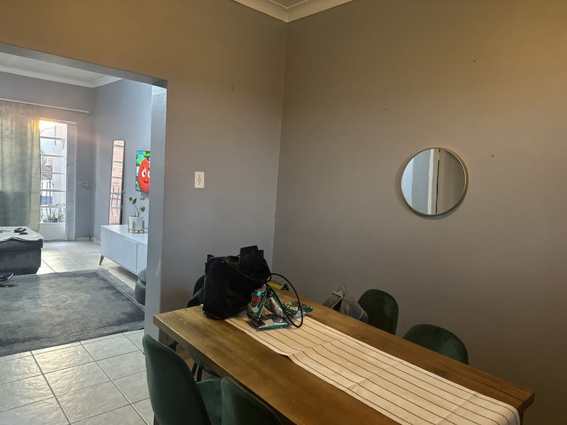 Open plan living and dining area featuring tiled flooring and neutral wall finishes, providing a functional space for daily living and entertaining.