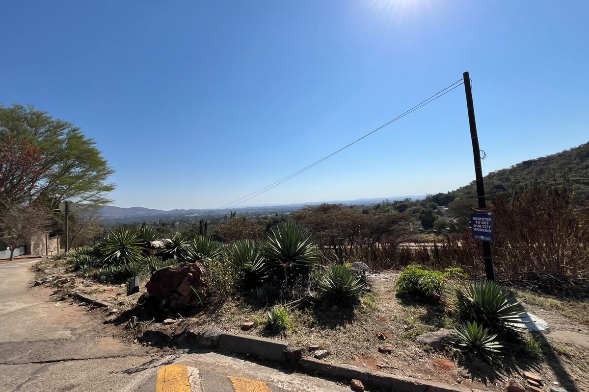A wide-angle view of the surrounding landscape and hillside from the edge of the residential property.
