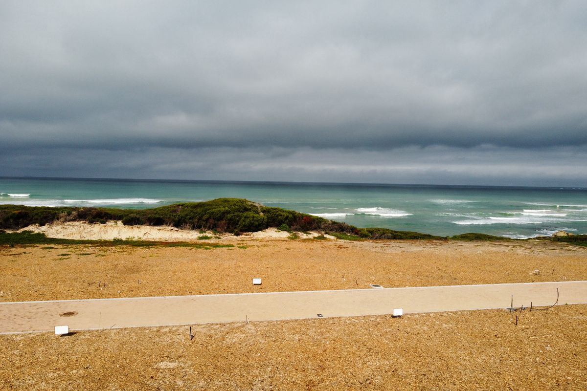 A scenic view of the ocean and coastal dunes from the vacant residential land plot.