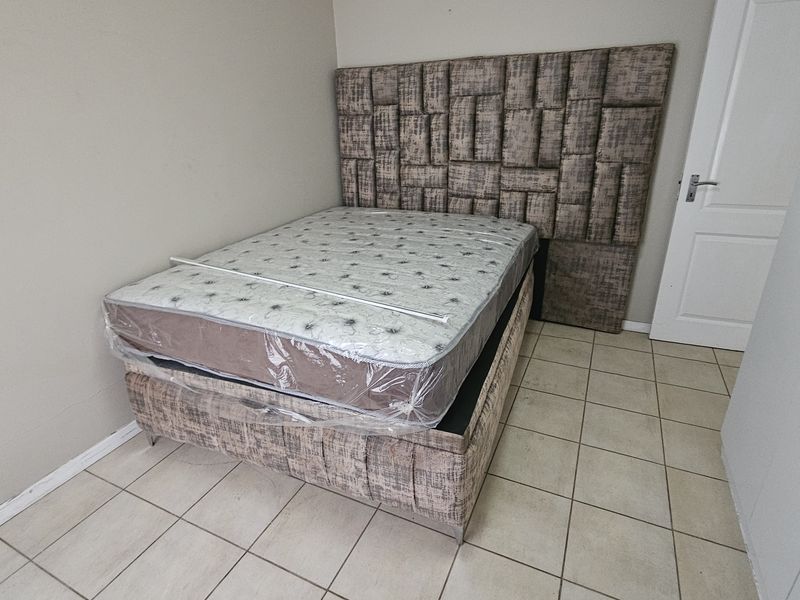 A bedroom featuring tiled flooring and a built-in wardrobe, providing a functional and neutral space.