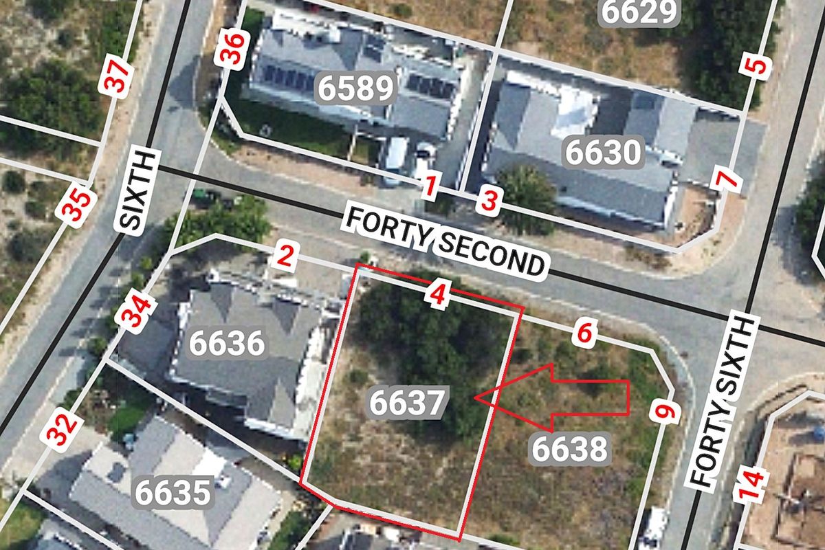Aerial view of a vacant residential land plot with marked boundaries, situated in a developed neighborhood.