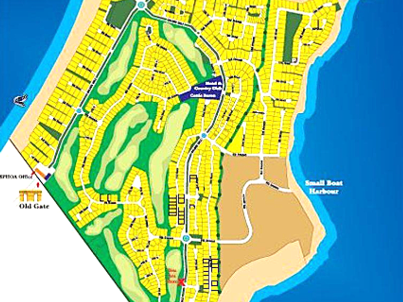 An illustrated site map showing the layout of the residential estate, including roads, plots, green spaces, and coastal access points.