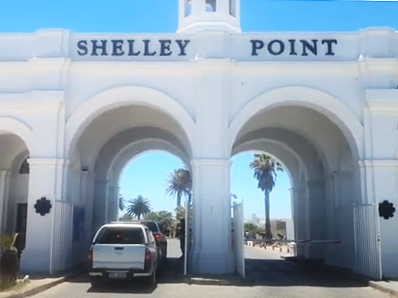 The main entrance gate and security access point for the Shelley Point estate, featuring a prominent white architectural archway.