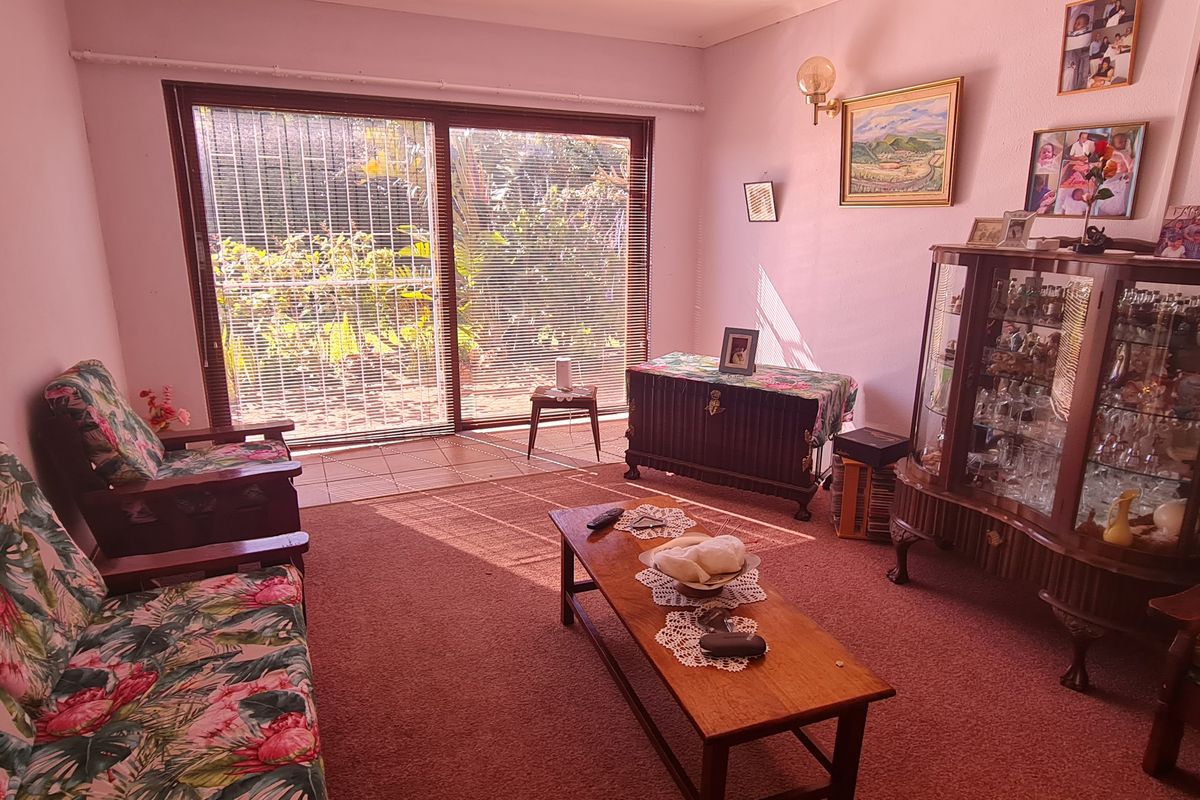 A living room featuring a large sliding glass door that provides natural light and access to the outdoor area.
