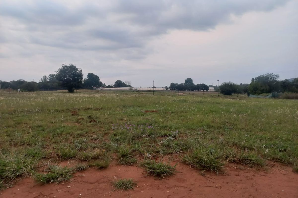 A view of an undeveloped residential plot of land featuring natural grass and open space.