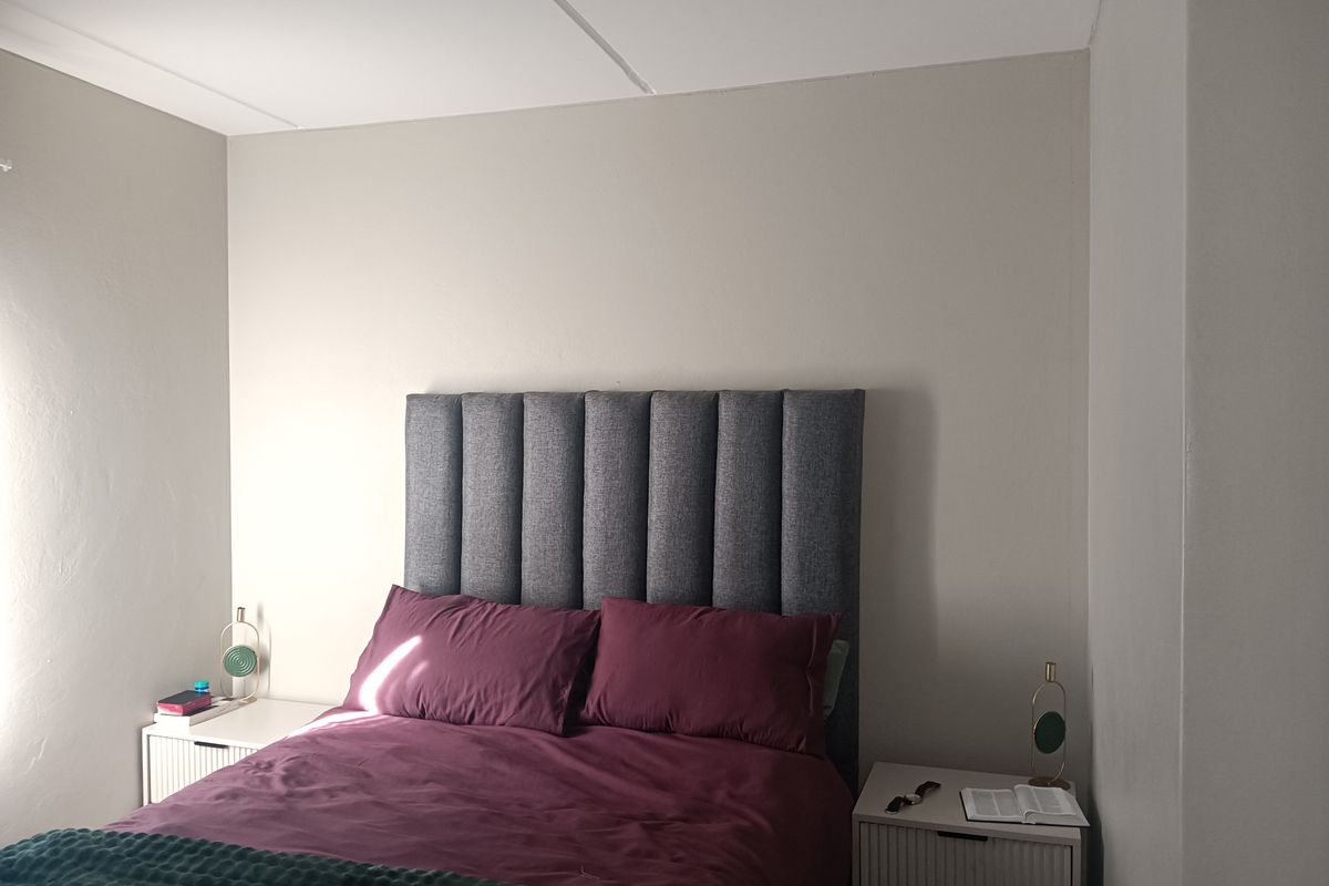 A simple bedroom featuring neutral wall tones and a clean layout, providing a comfortable and functional sleeping space.