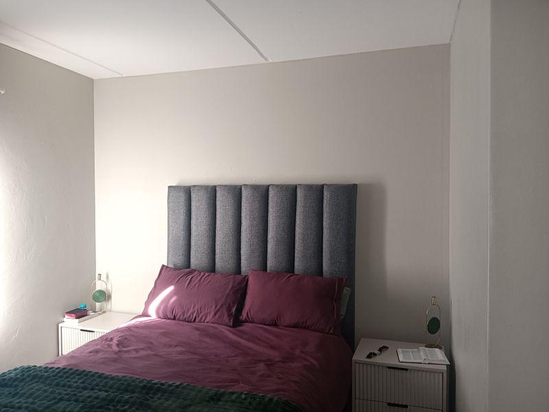 A simple bedroom featuring neutral wall tones and a clean layout, providing a comfortable and functional sleeping space.