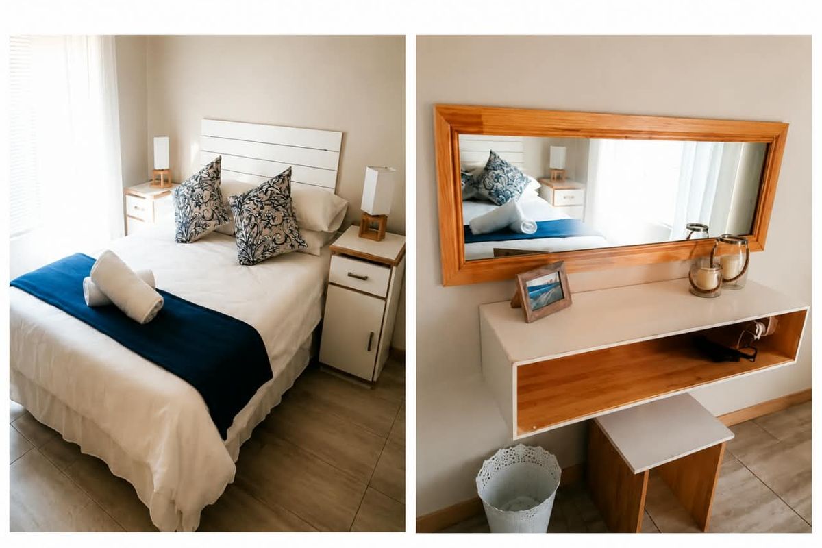 A bedroom featuring tiled flooring, a built-in vanity unit with a wooden-framed mirror, and neutral wall finishes.