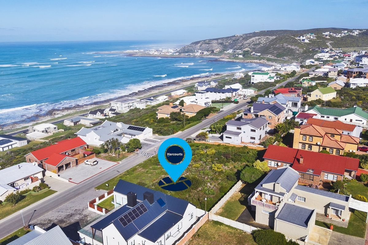 Aerial view of a vacant residential plot situated in a coastal neighborhood, offering proximity to the ocean and established residential infrastructure.