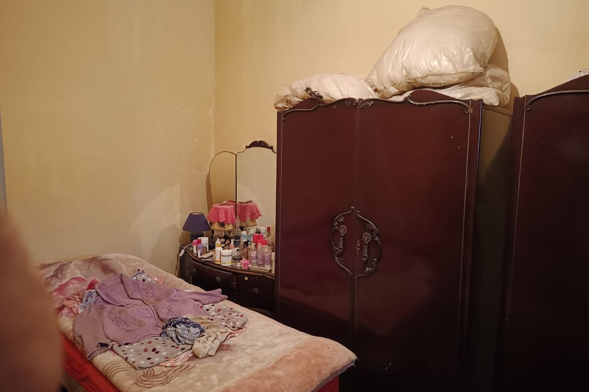 A bedroom space featuring plain wall finishes, suitable for renovation and modernization to enhance the living area.