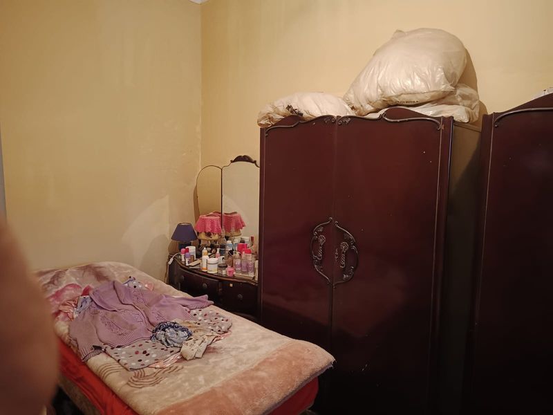 A bedroom space featuring plain wall finishes, suitable for renovation and modernization to enhance the living area.