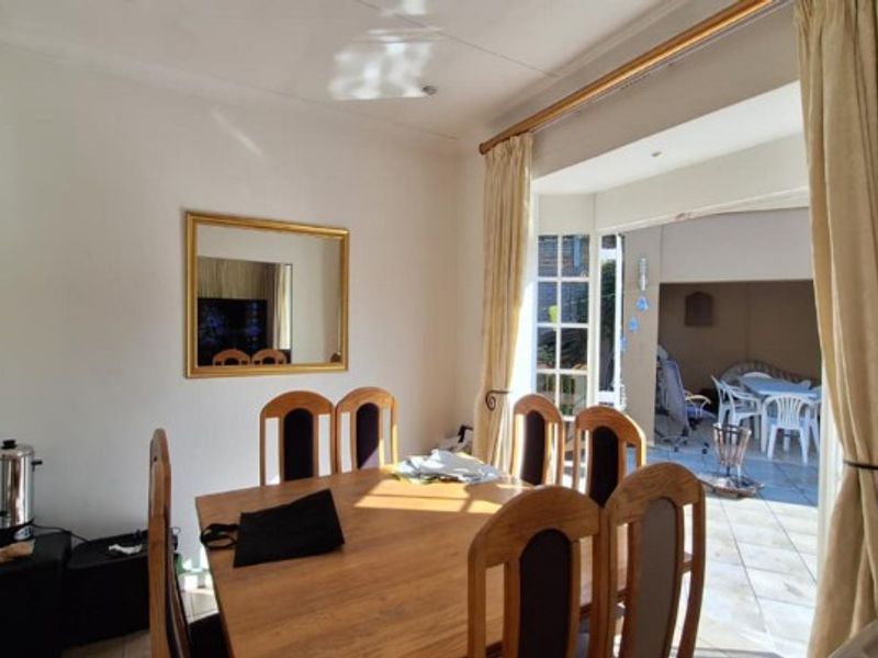 Dining room area featuring tiled flooring and direct access to an outdoor patio through sliding doors.