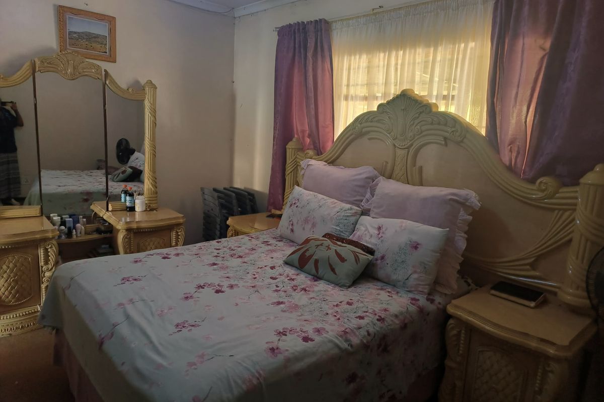 A bedroom featuring a window with curtain rails, providing natural light and a functional layout for a sleeping space.