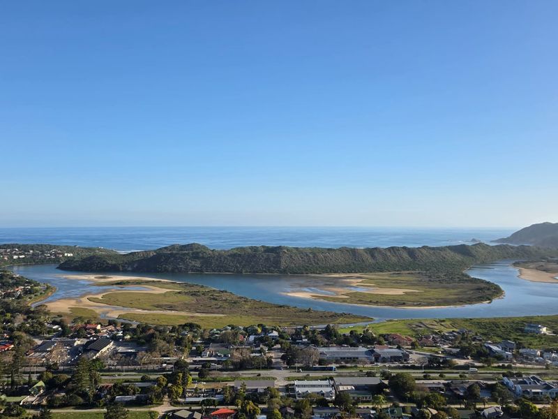 A scenic elevated view overlooking the coastal landscape, river estuary, and surrounding residential area.