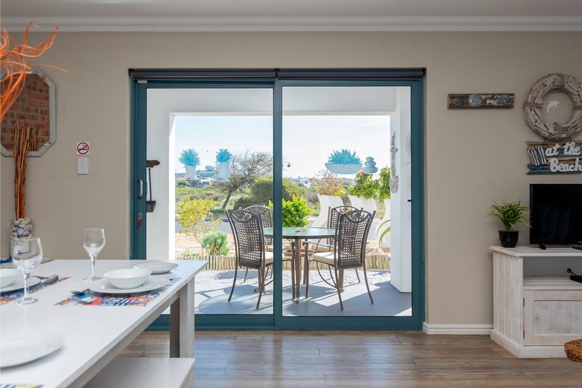 A bright living area featuring large sliding glass doors that provide seamless access to an outdoor patio space.