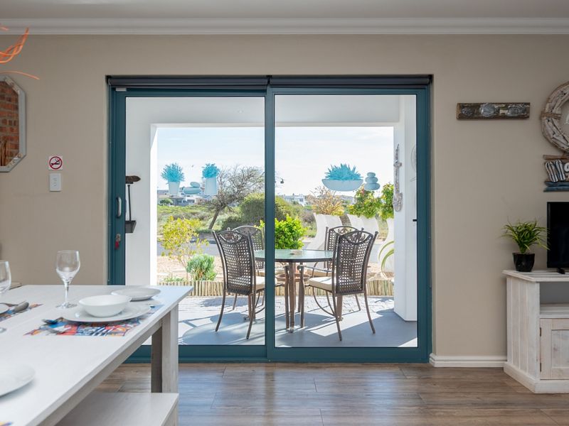 A bright living area featuring large sliding glass doors that provide seamless access to an outdoor patio space.