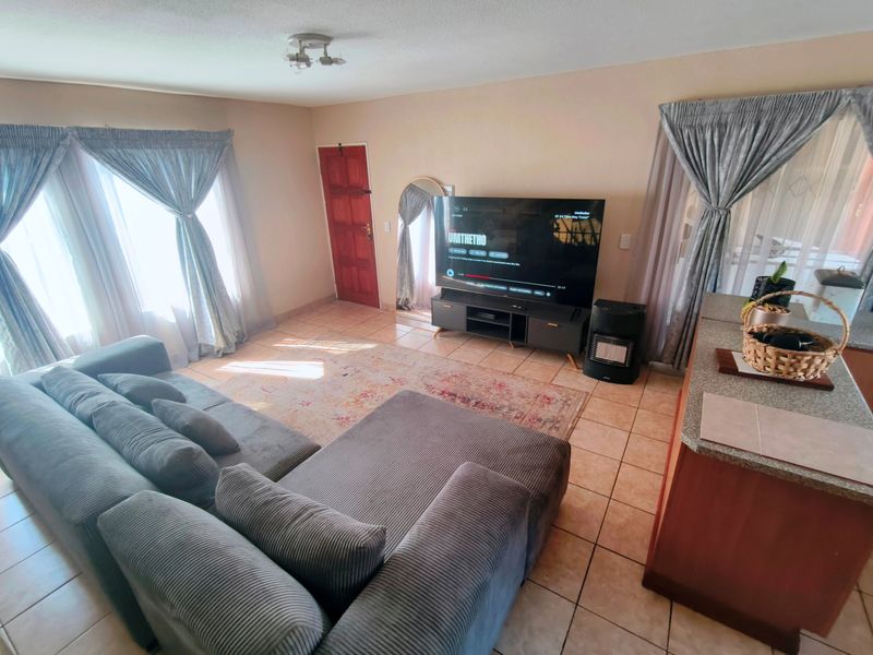 Open plan living area featuring tiled flooring and direct access to the main entrance.