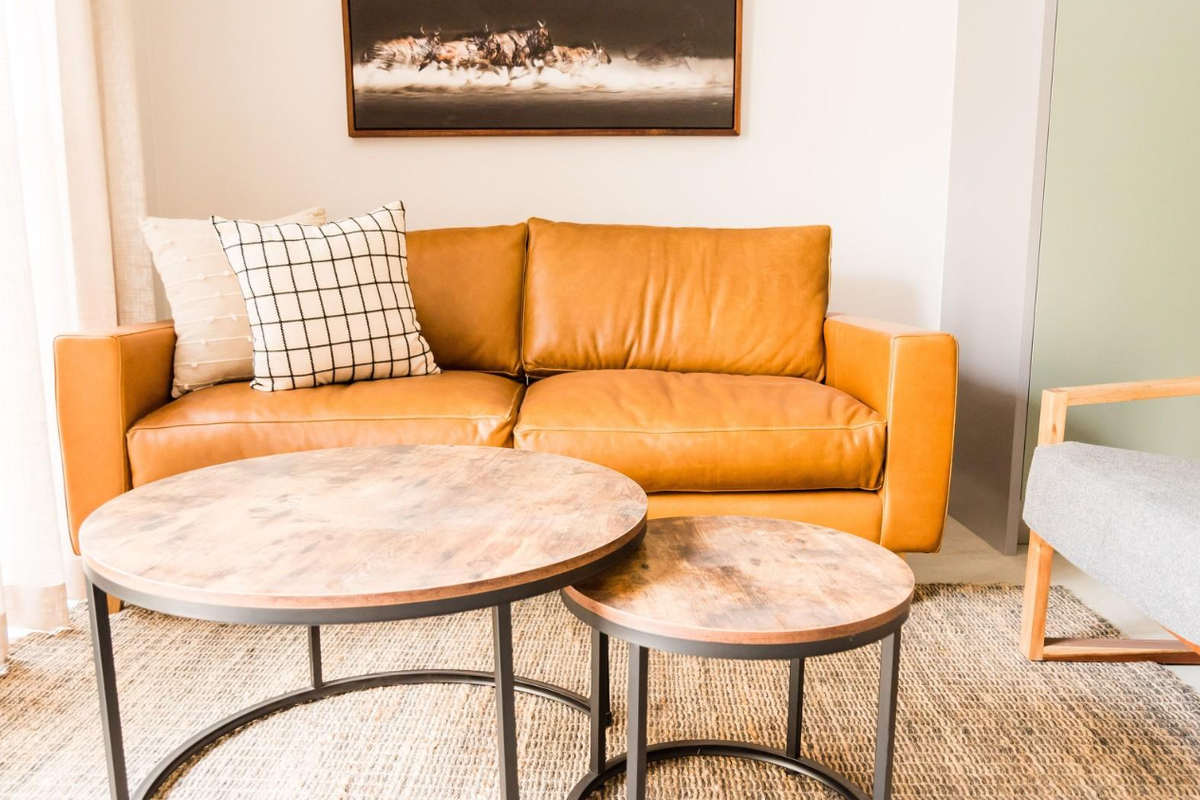 A well-lit living room area featuring neutral wall finishes and modern interior styling.