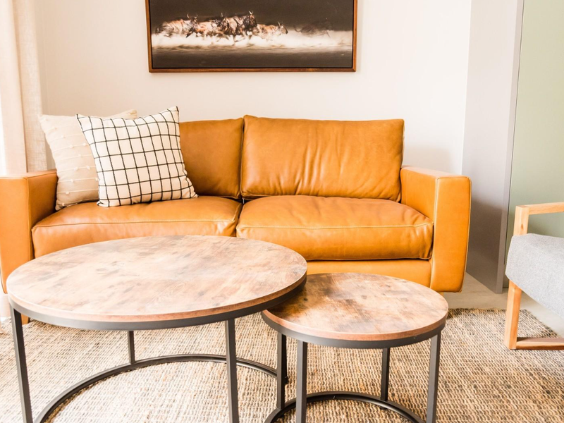 A well-lit living room area featuring neutral wall finishes and modern interior styling.