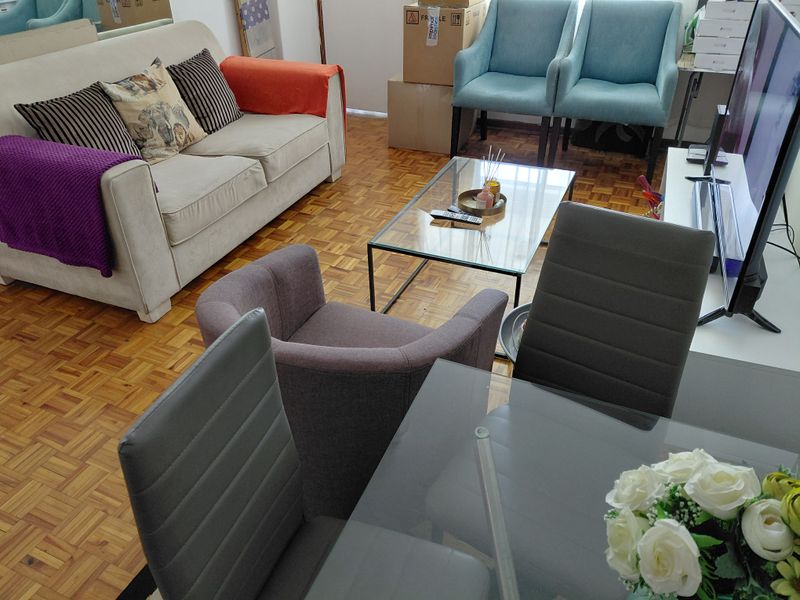 Open plan living and dining area featuring classic parquet flooring throughout the space.