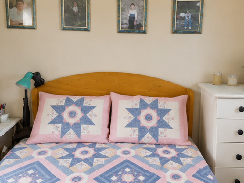 A cozy bedroom featuring a wooden headboard and neutral wall finishes, providing a comfortable and functional sleeping space.