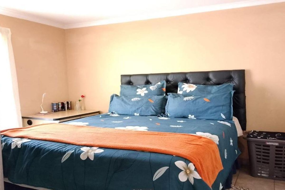 A standard bedroom featuring neutral wall tones and cove cornicing, providing a functional and comfortable sleeping space.