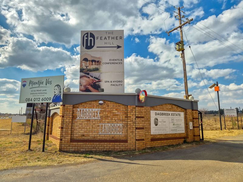 Entrance view of Dagbreek Estate featuring brick boundary walling, estate signage, and utility infrastructure.