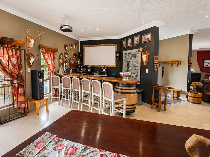 A dedicated entertainment bar area featuring a built-in counter, projection screen, and integrated projector, ideal for hosting and social gatherings.