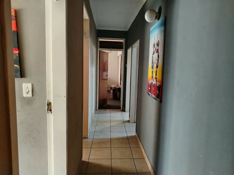 A functional hallway featuring tiled flooring and access to multiple rooms, providing a central circulation space within the home.