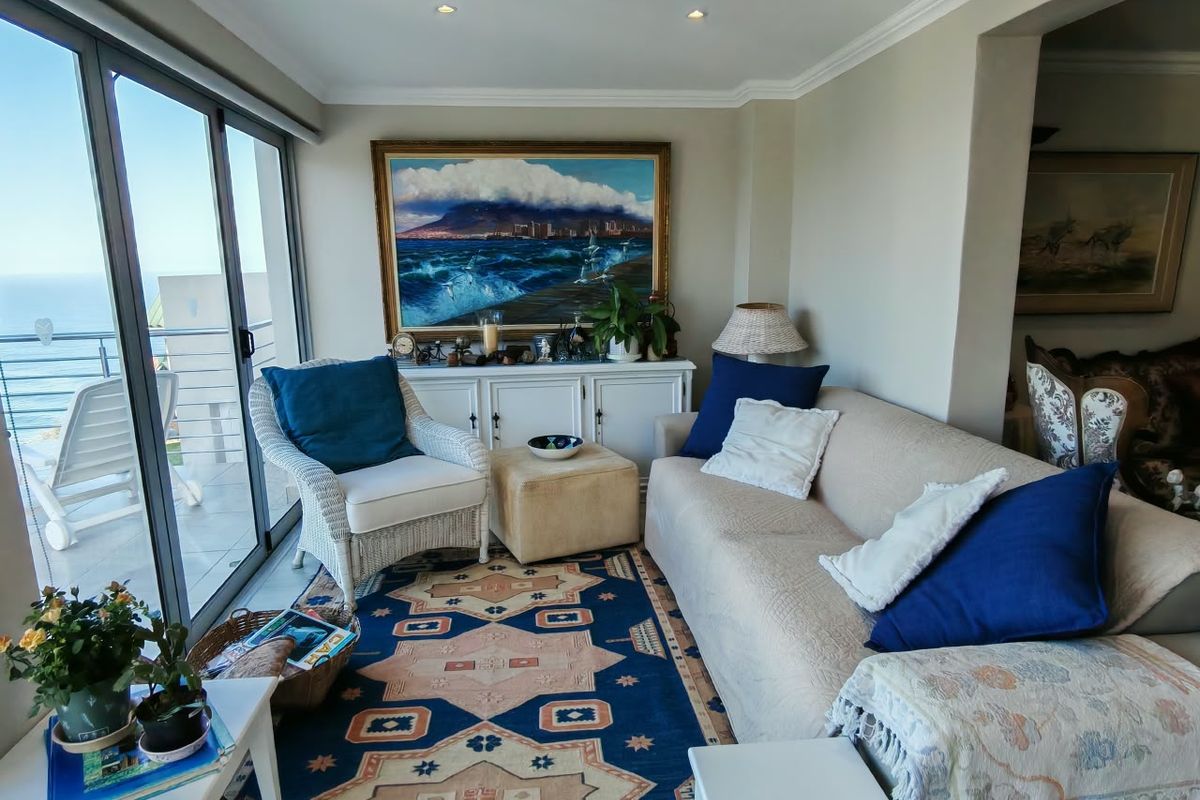 A comfortable living room featuring large sliding glass doors that provide natural light and access to an outdoor balcony area.