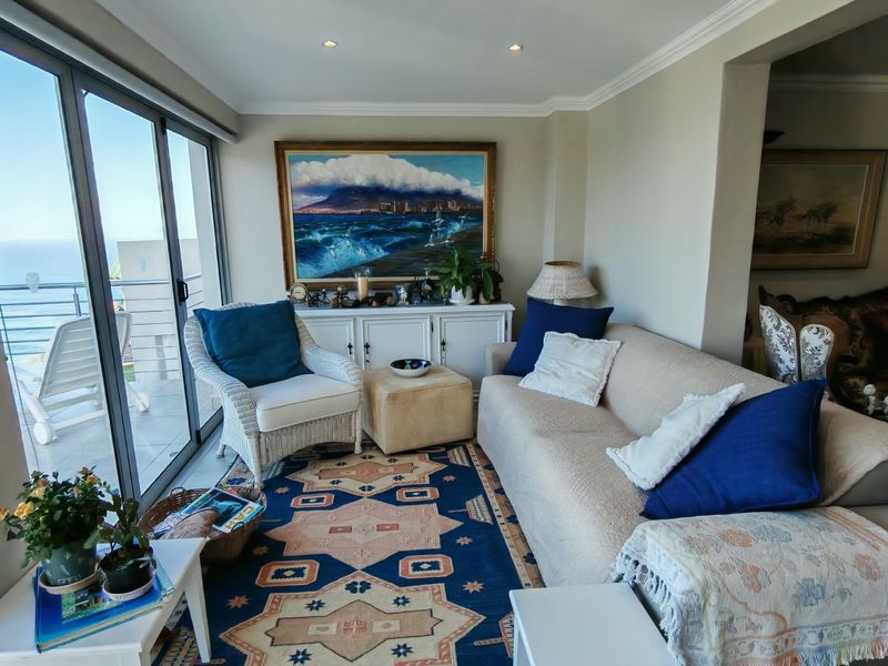 A comfortable living room featuring large sliding glass doors that provide natural light and access to an outdoor balcony area.