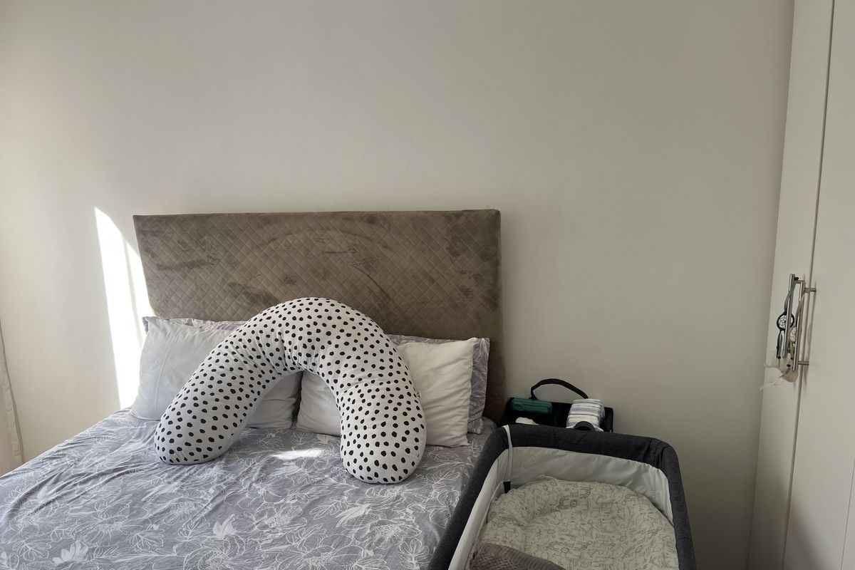 A bedroom featuring a neutral wall finish and a built-in wardrobe, providing functional storage space.