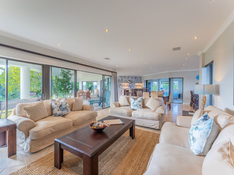 Spacious open-plan living area featuring large sliding glass doors that provide seamless access to the outdoor patio and abundant natural light.