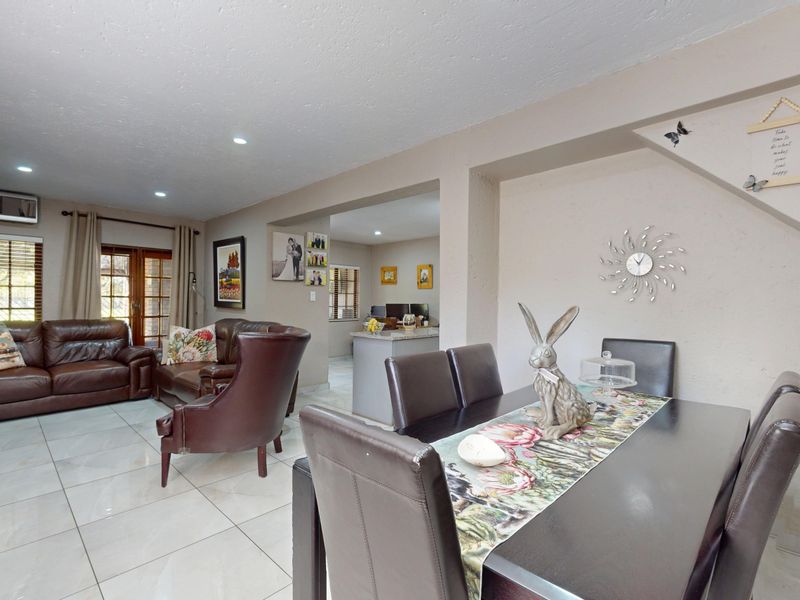 Spacious open-plan living and dining area featuring tiled flooring, recessed lighting, and a seamless transition to the kitchen space.
