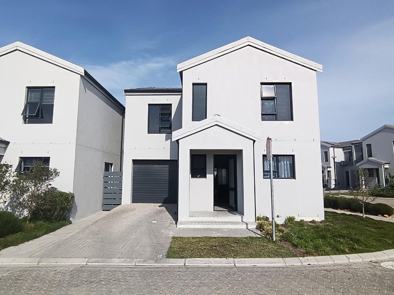 Modern double-storey residential home featuring a paved driveway, single garage, and clean architectural lines in a well-maintained estate setting.