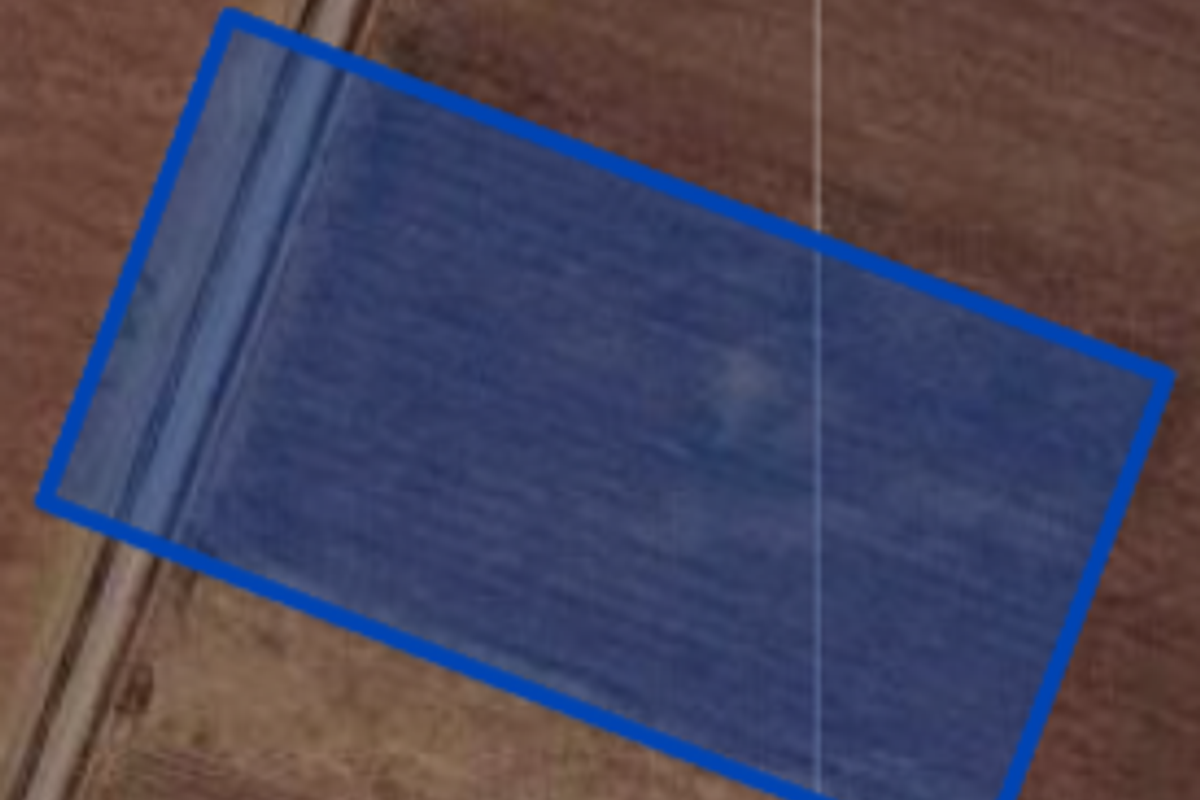 An aerial view showing the boundaries of the vacant residential land plot.