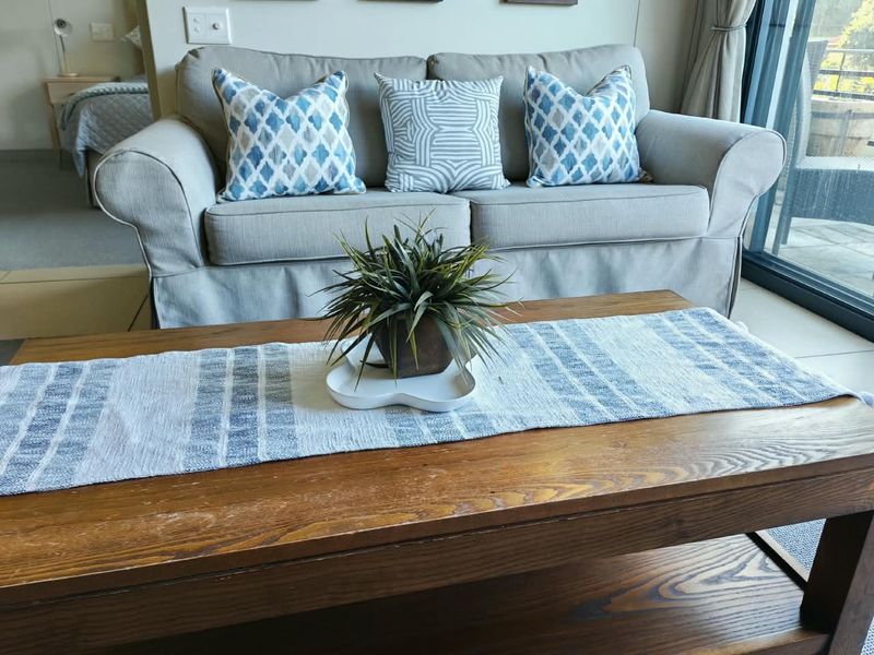 A comfortable living area featuring tiled flooring and a large sliding glass door providing access to the outdoor space.