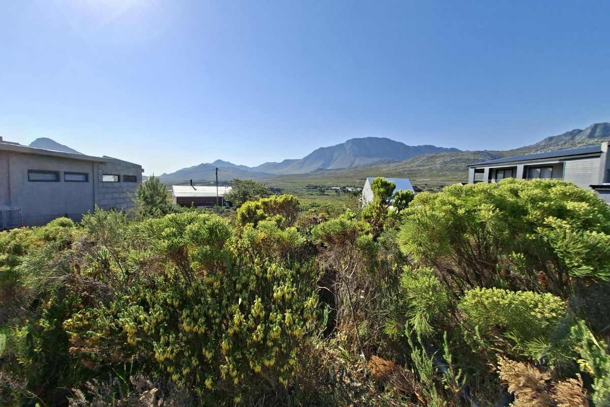 A scenic view of the surrounding landscape featuring native vegetation and distant mountain ranges from the residential property.