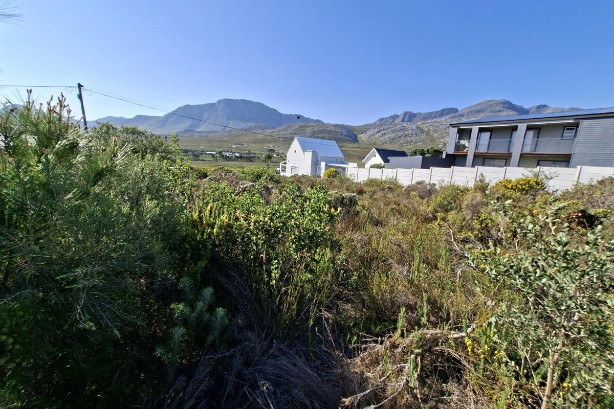 A scenic view of the surrounding landscape and mountains from the vacant residential land plot.