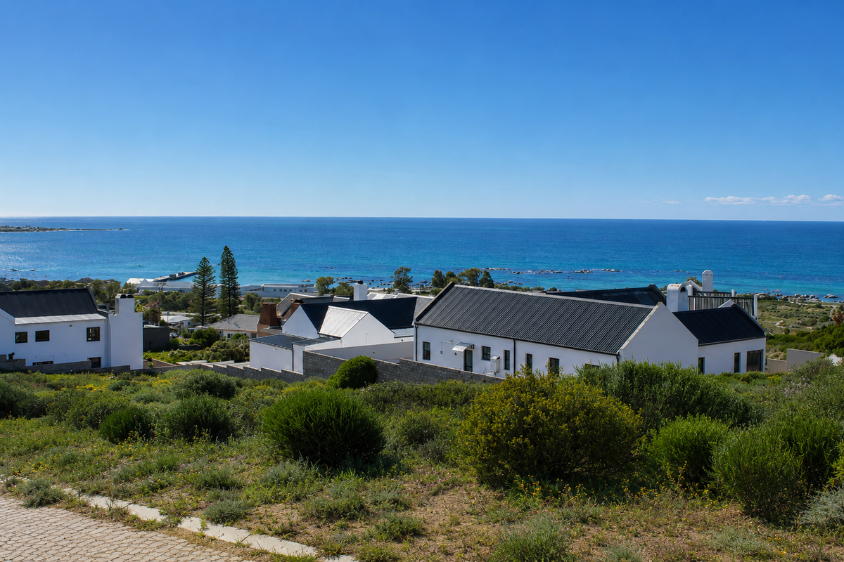 A scenic elevated view overlooking a coastal residential area with clear blue ocean horizons.