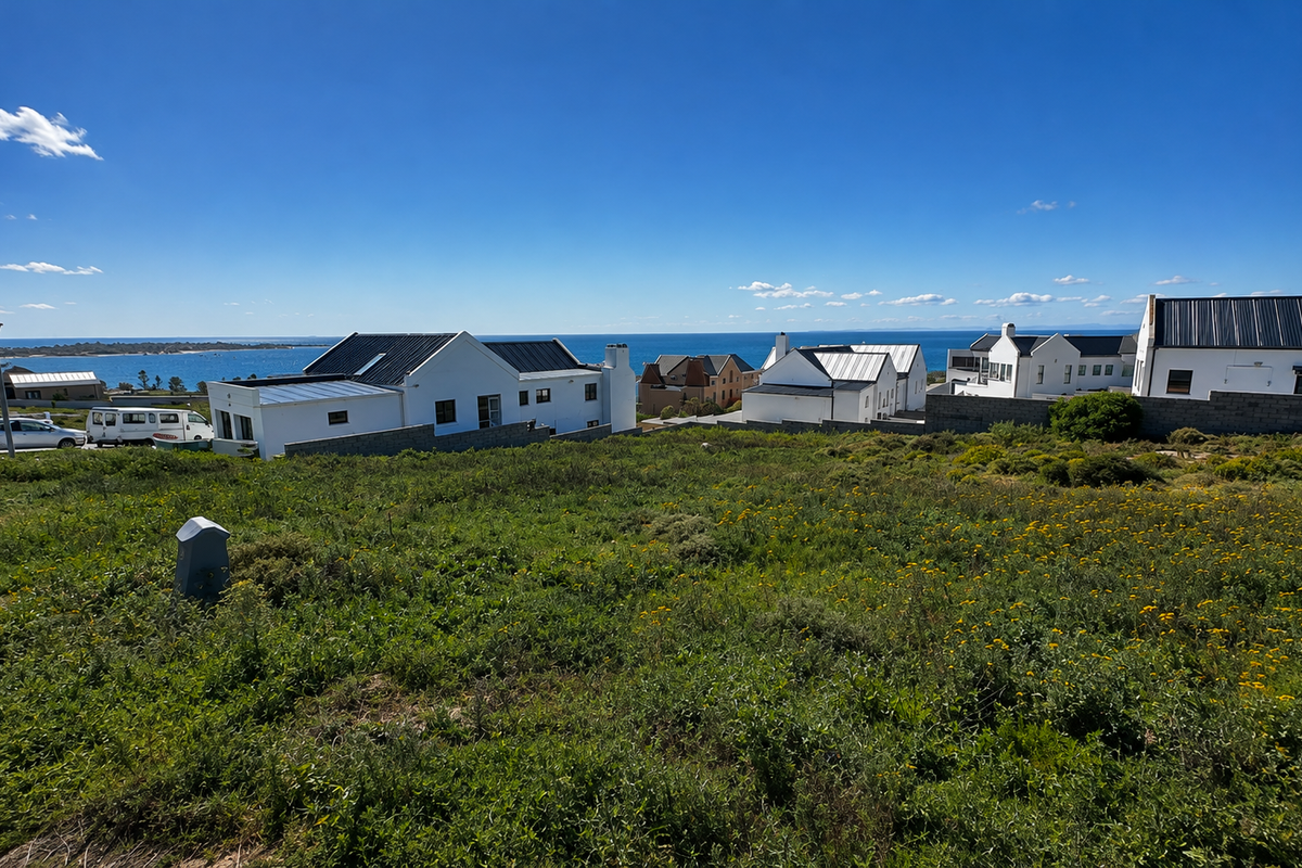 A scenic view overlooking the coastal landscape and ocean from the vacant residential land, showcasing the surrounding neighborhood and horizon.