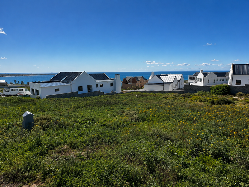 A scenic view overlooking the coastal landscape and ocean from the vacant residential land, showcasing the surrounding neighborhood and horizon.