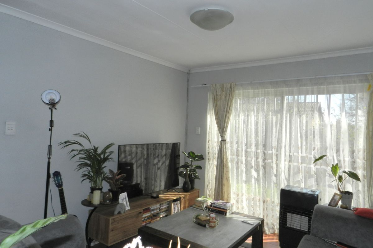 A comfortable living room featuring a sliding glass door that provides natural light and access to the outdoor area.
