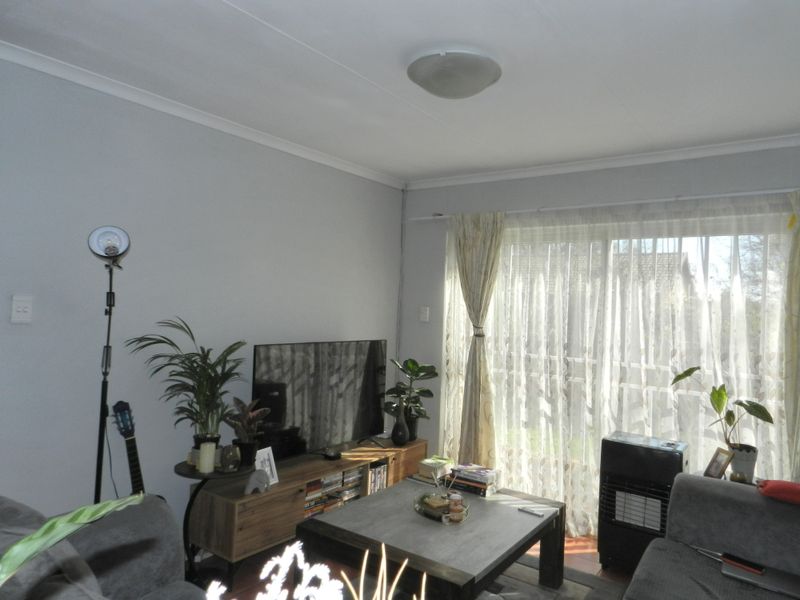 A comfortable living room featuring a sliding glass door that provides natural light and access to the outdoor area.