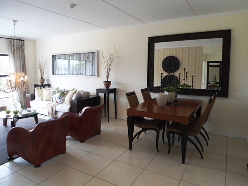 Spacious open-plan living and dining area featuring neutral tiled flooring and a bright, functional layout suitable for modern living.