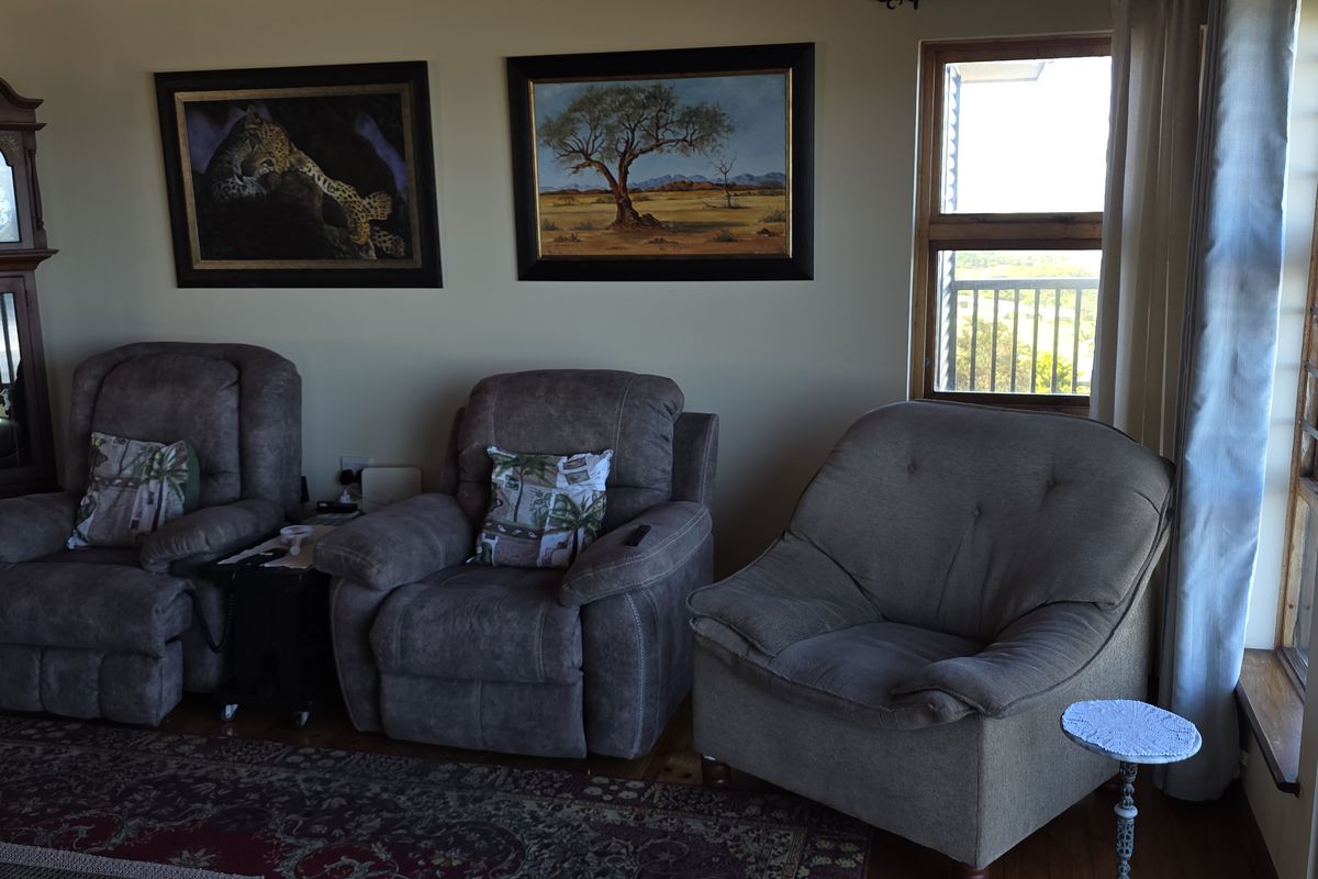 A comfortable living room featuring hardwood flooring and a sliding glass door that provides access to an outdoor balcony area.